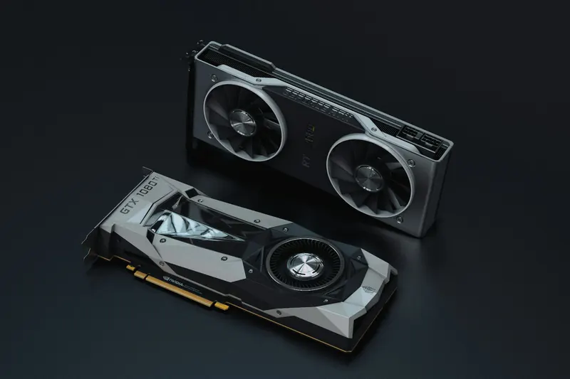 Two NVIDIA graphics cards photographed together on a dark surface, with their fans and cooling systems visible